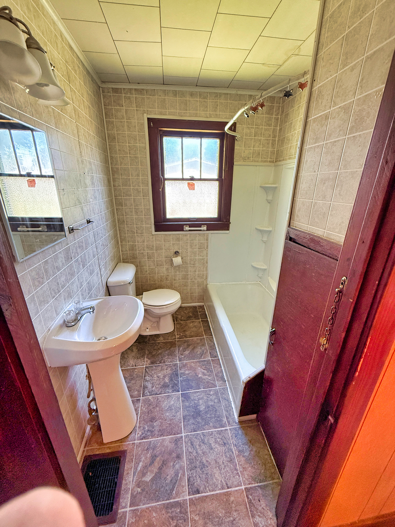 426 South Locust Street Flora, IL 62839 - Photo 35 of 58 a bathroom with a sink a toilet and a shower