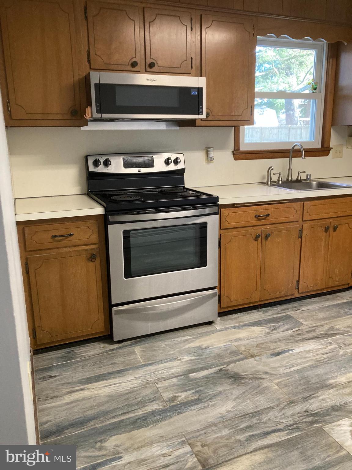 14104 Schaeffer Road Germantown, MD 20874 - Photo 11 of 42 a kitchen with granite countertop a stove and a sink