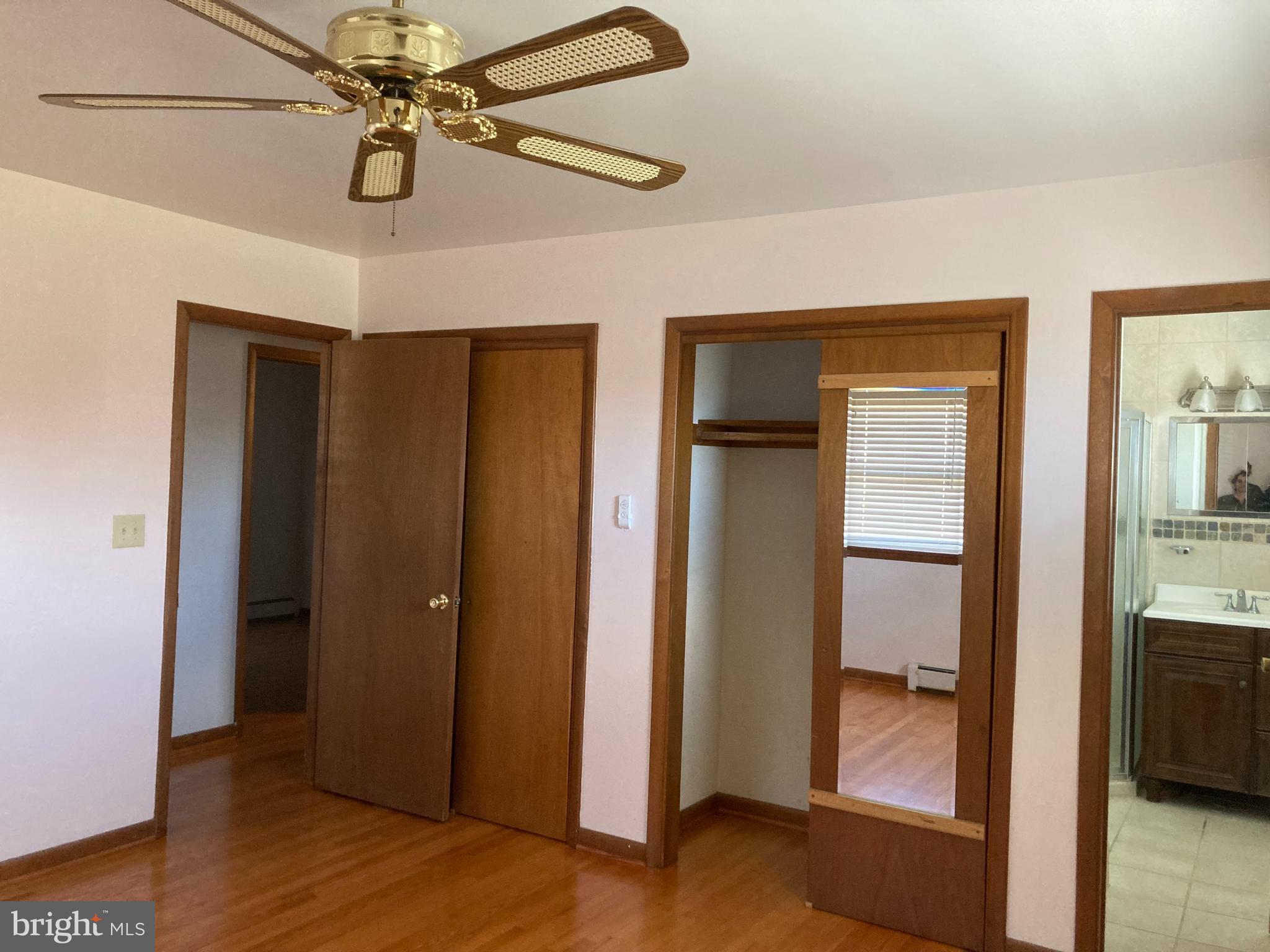 14104 Schaeffer Road Germantown, MD 20874 - Photo 12 of 42 a view of a hallway with wooden floor and a ceiling fan