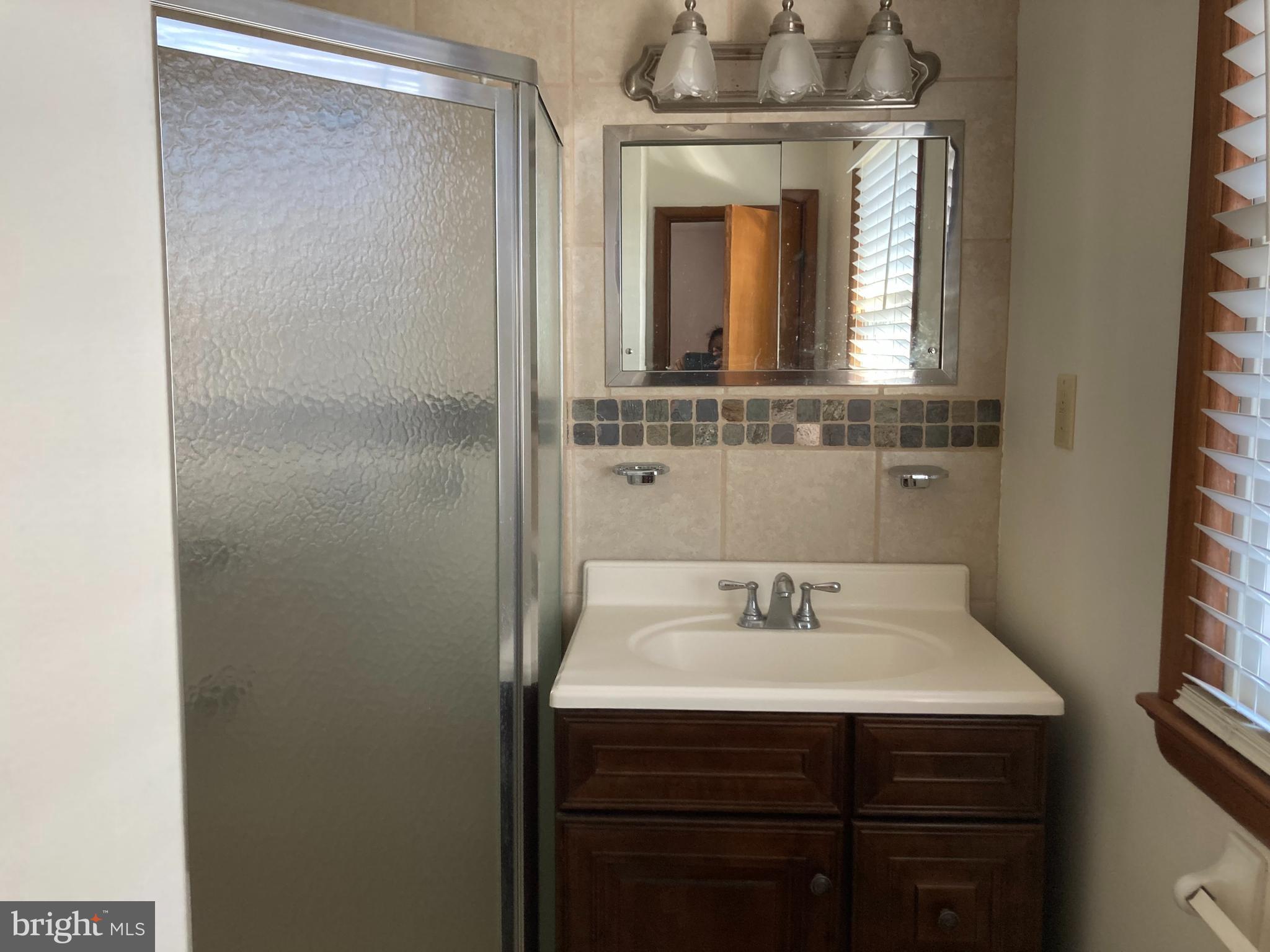 14104 Schaeffer Road Germantown, MD 20874 - Photo 14 of 42 a bathroom with a sink and a mirror