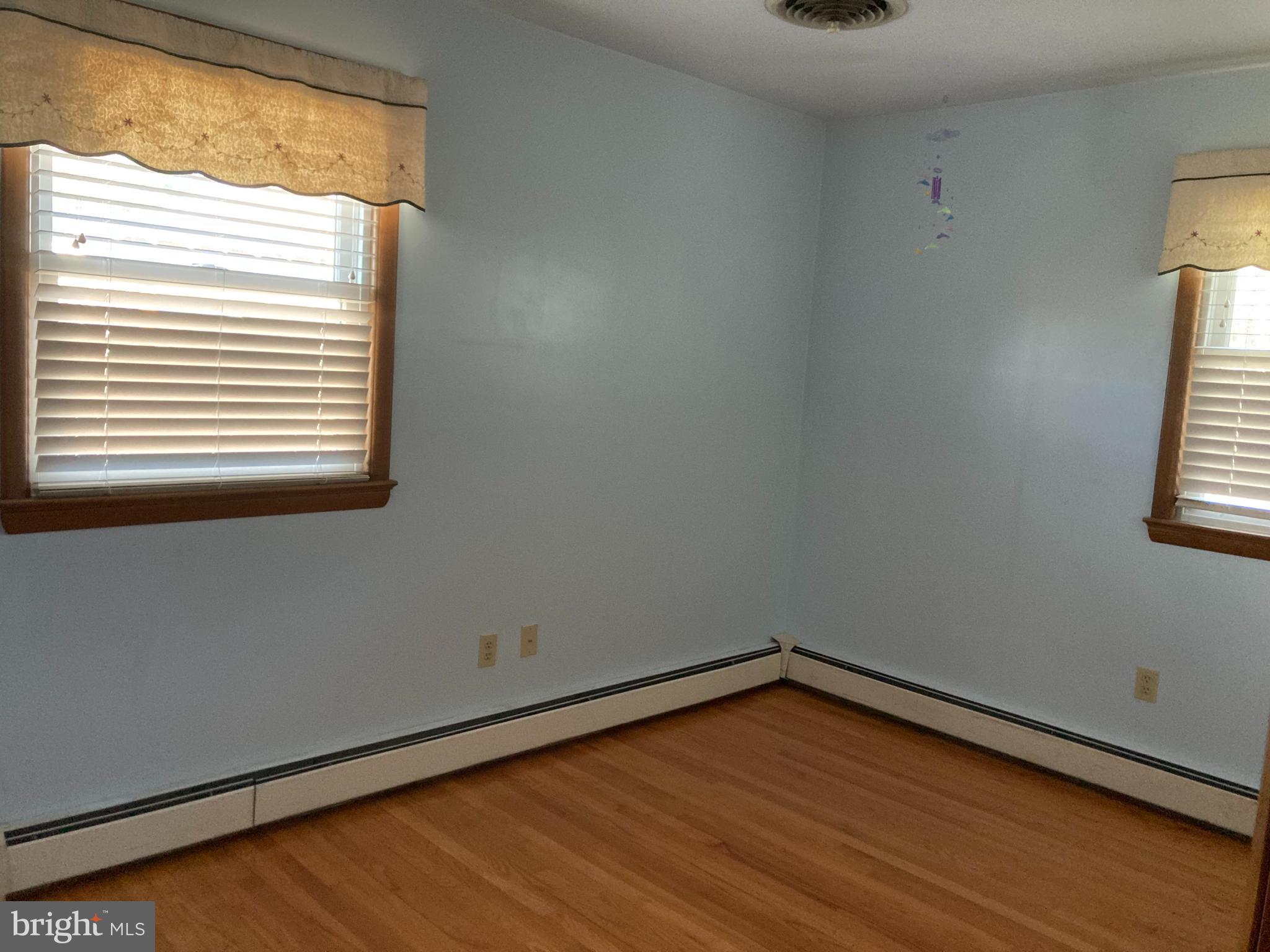 14104 Schaeffer Road Germantown, MD 20874 - Photo 16 of 42 a view of an empty room with wooden floor and a window