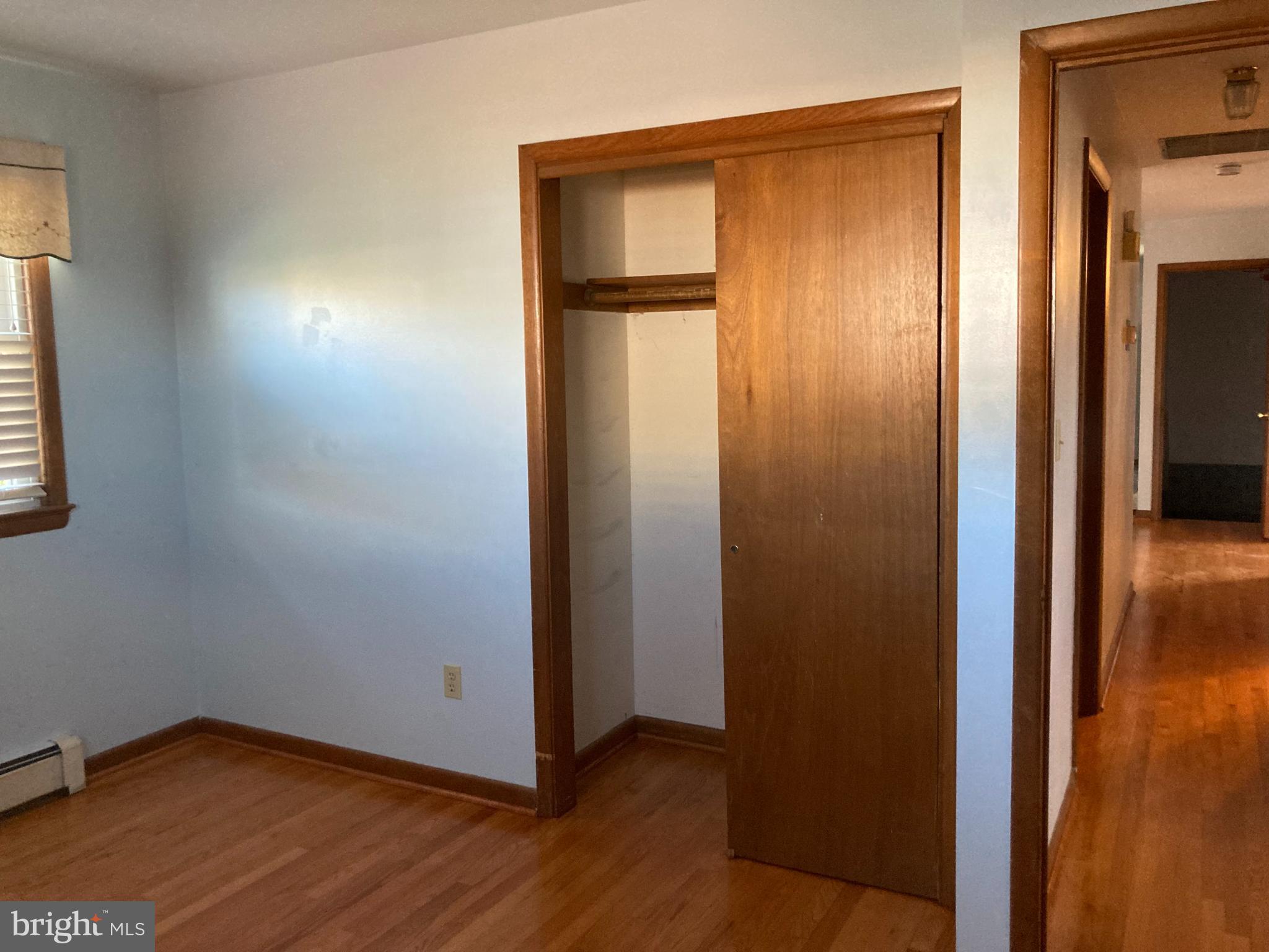 14104 Schaeffer Road Germantown, MD 20874 - Photo 17 of 42 an empty room with wooden floor and closet