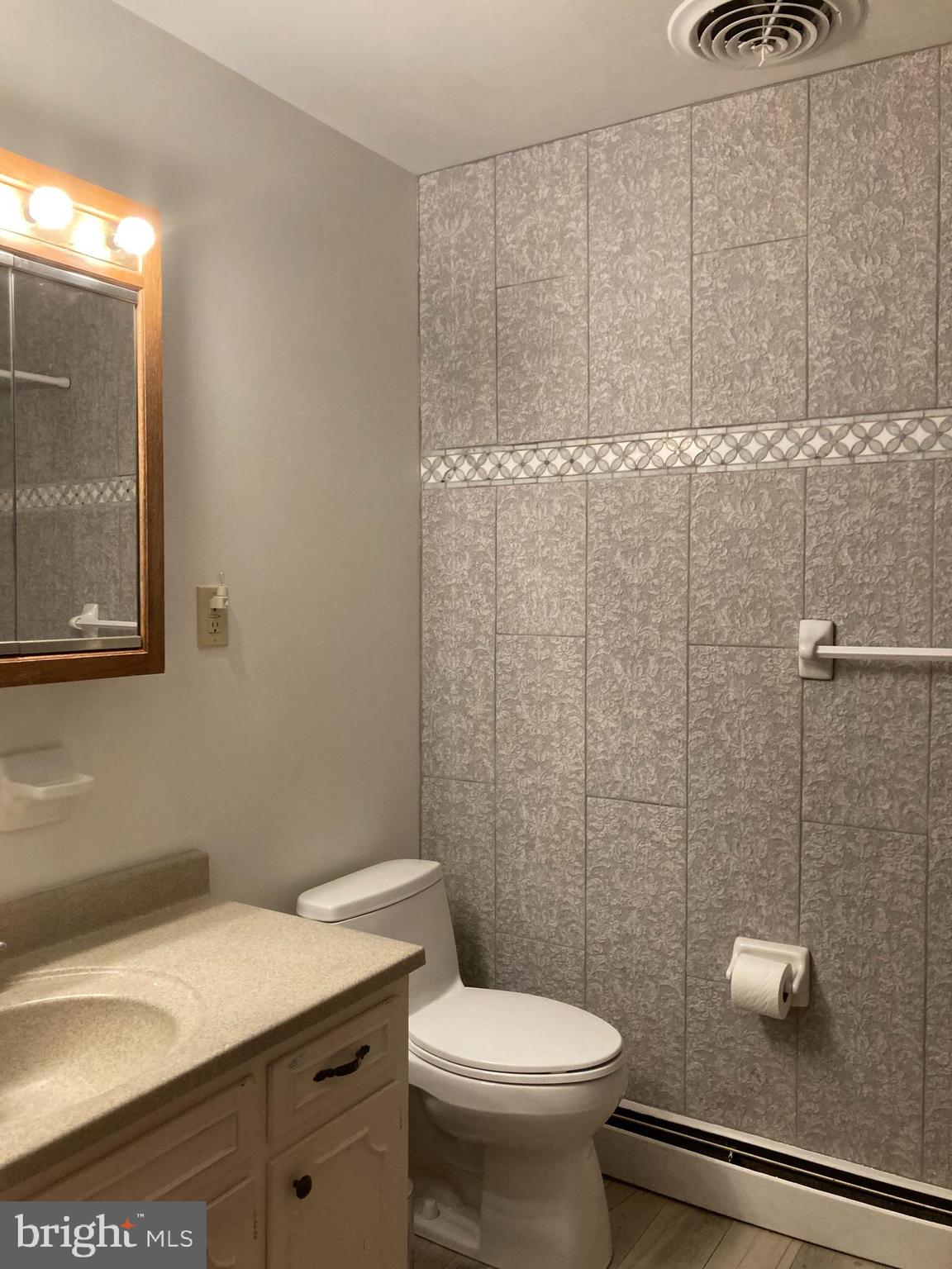 14104 Schaeffer Road Germantown, MD 20874 - Photo 20 of 42 a bathroom with a sink a toilet and shower