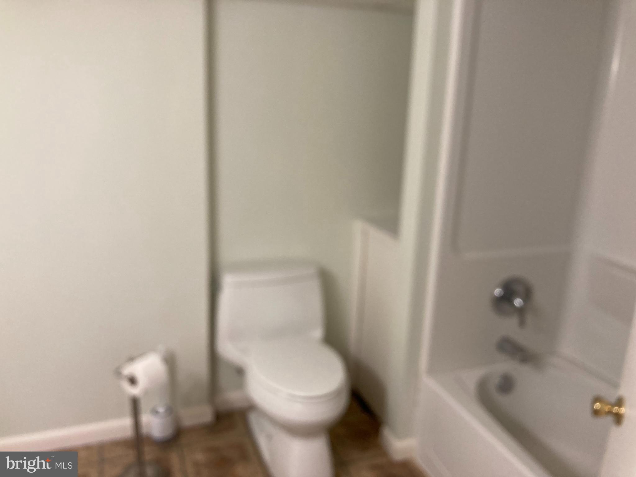 14104 Schaeffer Road Germantown, MD 20874 - Photo 30 of 42 a white toilet sitting next to a bath tub