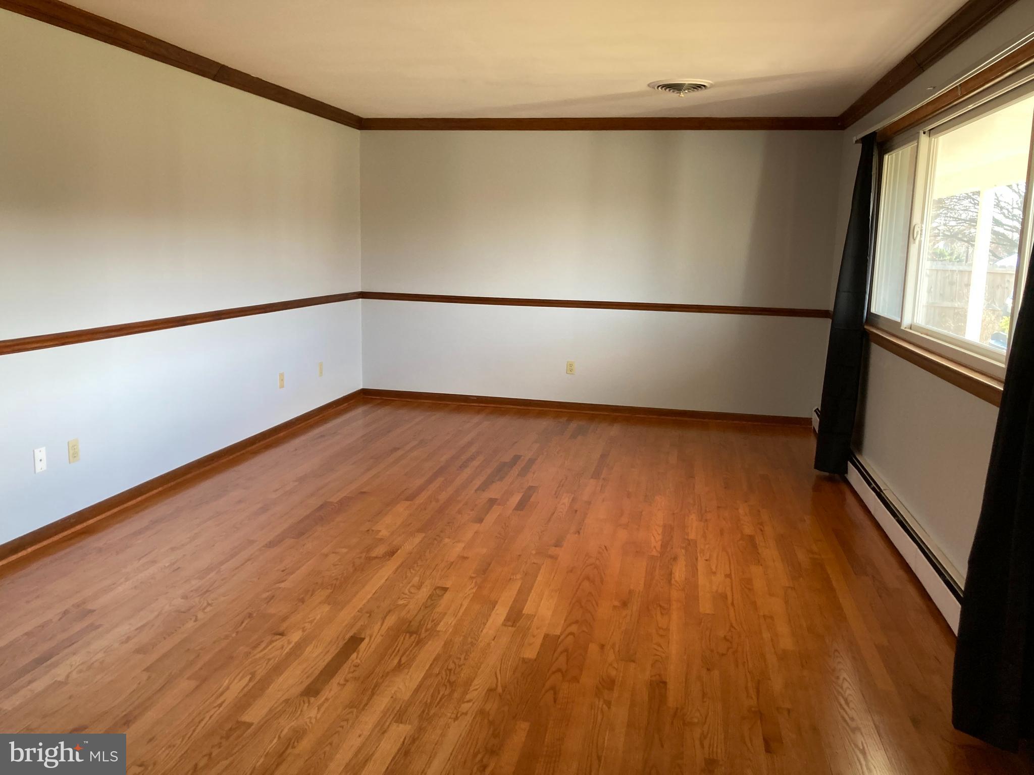 14104 Schaeffer Road Germantown, MD 20874 - Photo 4 of 42 a view of an empty room with wooden floor and a window