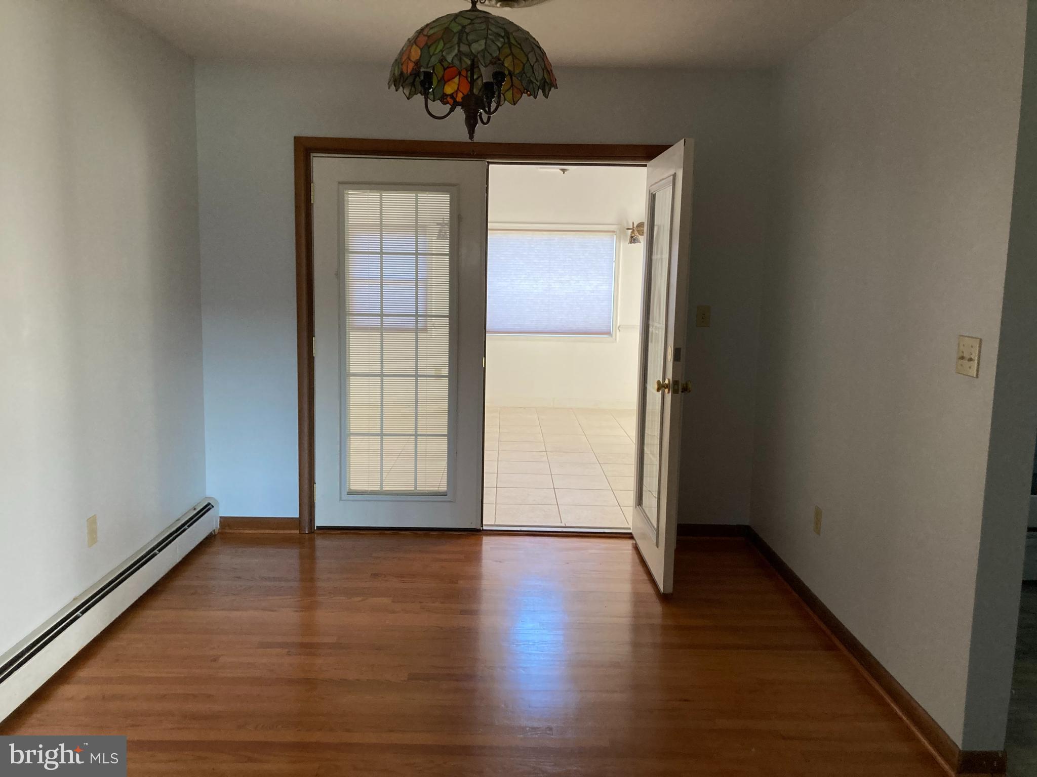 14104 Schaeffer Road Germantown, MD 20874 - Photo 7 of 42 a view of an empty room with wooden floor and a window