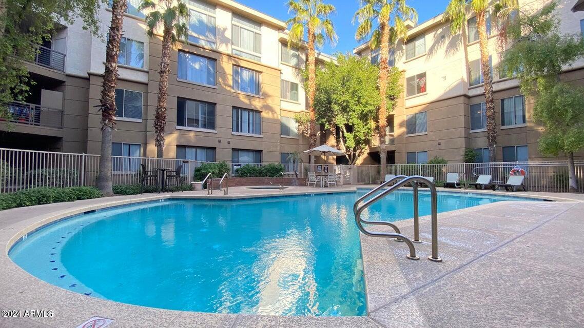 1701 East Colter Street, Unit 165 Phoenix, AZ 85016 - Photo 18 of 33 a swimming pool with outdoor seating and yard
