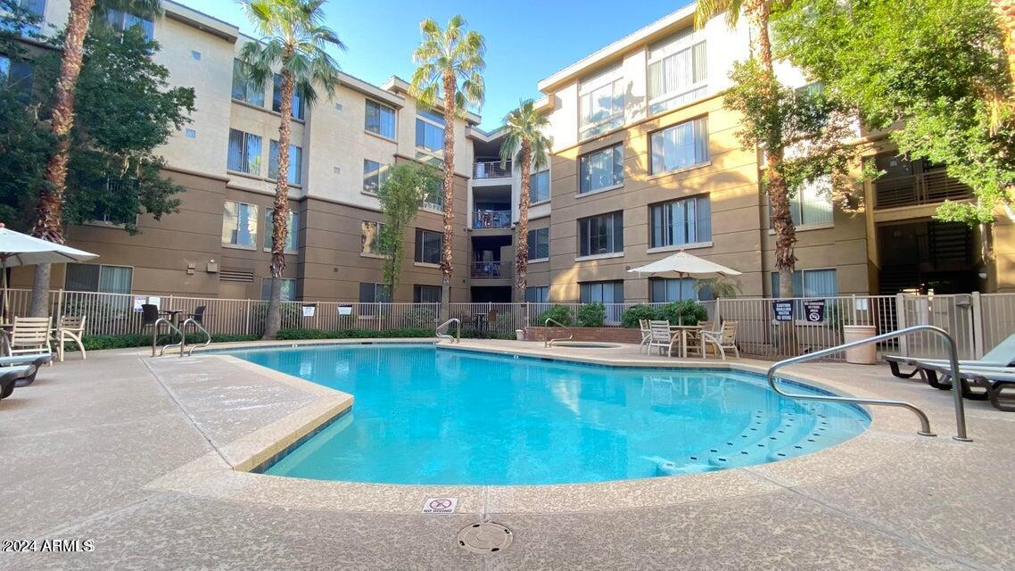 1701 East Colter Street, Unit 165 Phoenix, AZ 85016 - Photo 19 of 33 a view of a swimming pool with outdoor seating