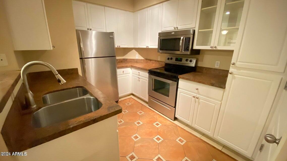 1701 East Colter Street, Unit 165 Phoenix, AZ 85016 - Photo 4 of 33 a kitchen with a sink and a refrigerator