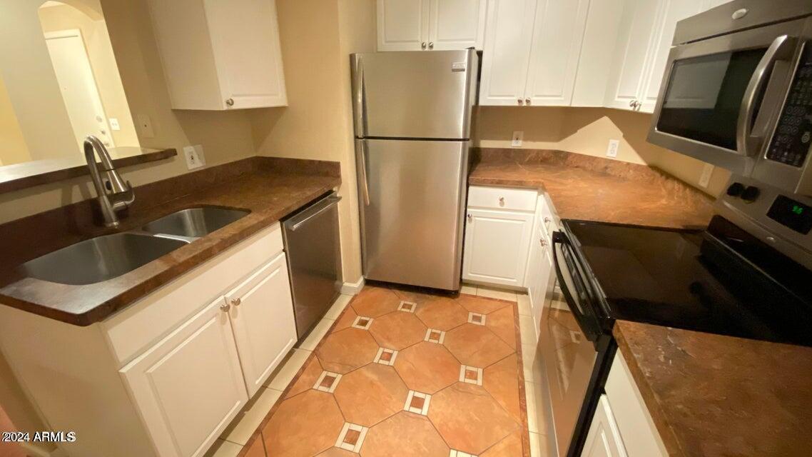 1701 East Colter Street, Unit 165 Phoenix, AZ 85016 - Photo 5 of 33 a kitchen with a refrigerator and a sink
