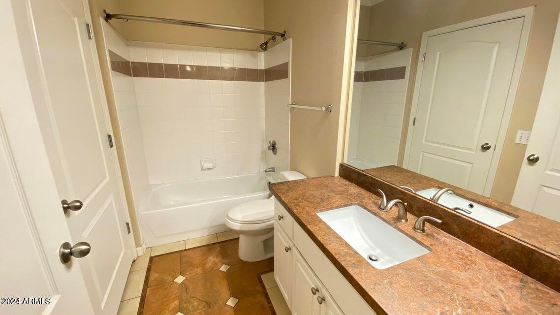 1701 East Colter Street, Unit 165 Phoenix, AZ 85016 - Photo 8 of 33 a bathroom with a granite countertop sink toilet and shower