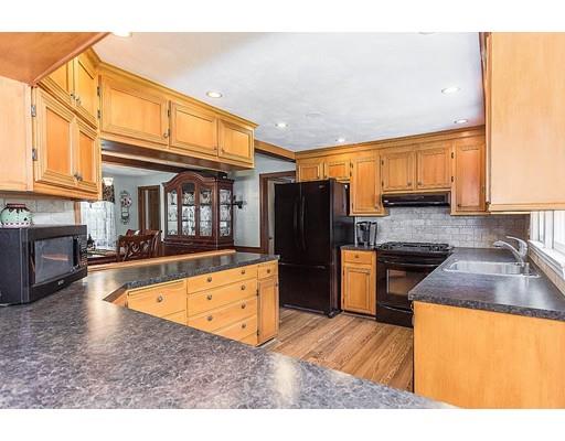 7 Galloway Road Chelmsford, MA 01824 - Photo 3 of 37 a kitchen with stainless steel appliances granite countertop a refrigerator a stove and a sink with wooden floors