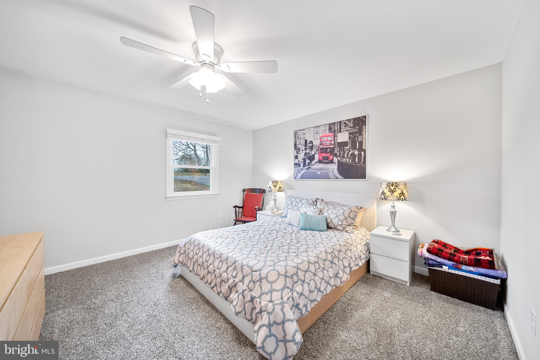 5344 Courtneys Corner Road Sumerduck, VA 22742 - Photo 19 of 56 a bedroom with a bed and a chandelier