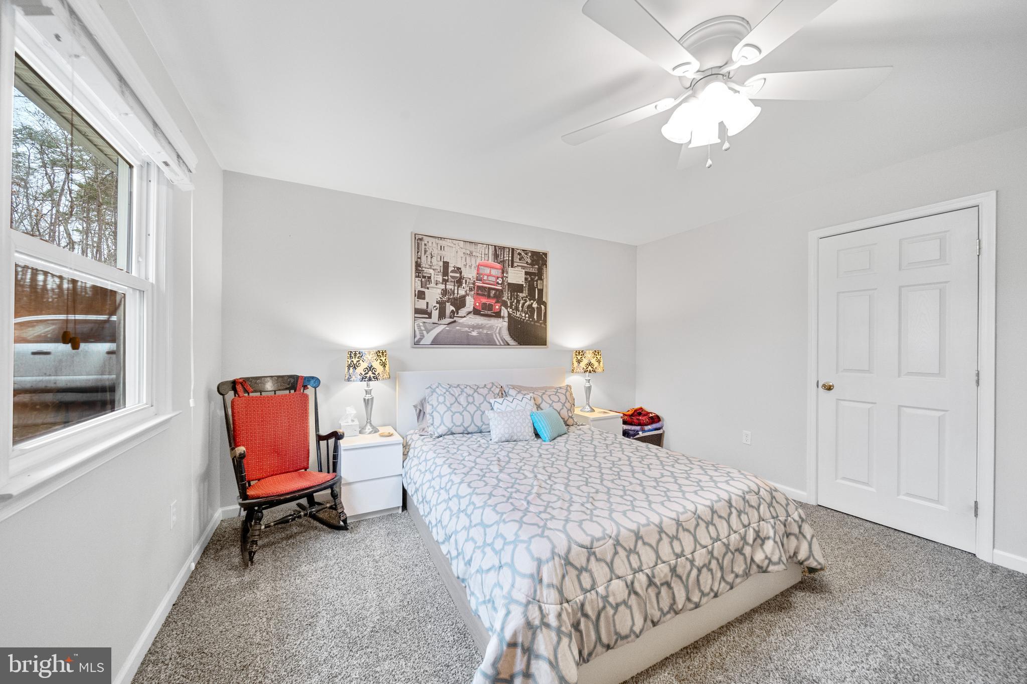 5344 Courtneys Corner Road Sumerduck, VA 22742 - Photo 20 of 56 a bedroom with a bed and a chandelier