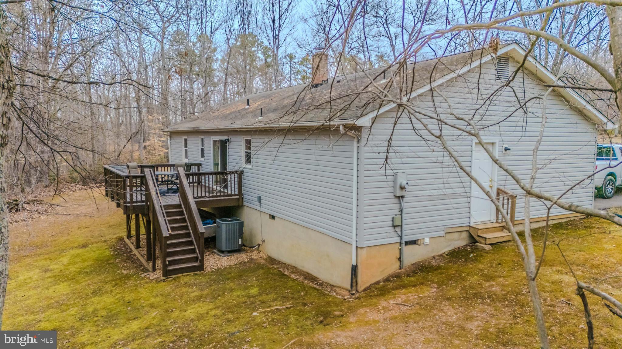 5344 Courtneys Corner Road Sumerduck, VA 22742 - Photo 27 of 56 a view of a patio with table and chairs under an umbrella