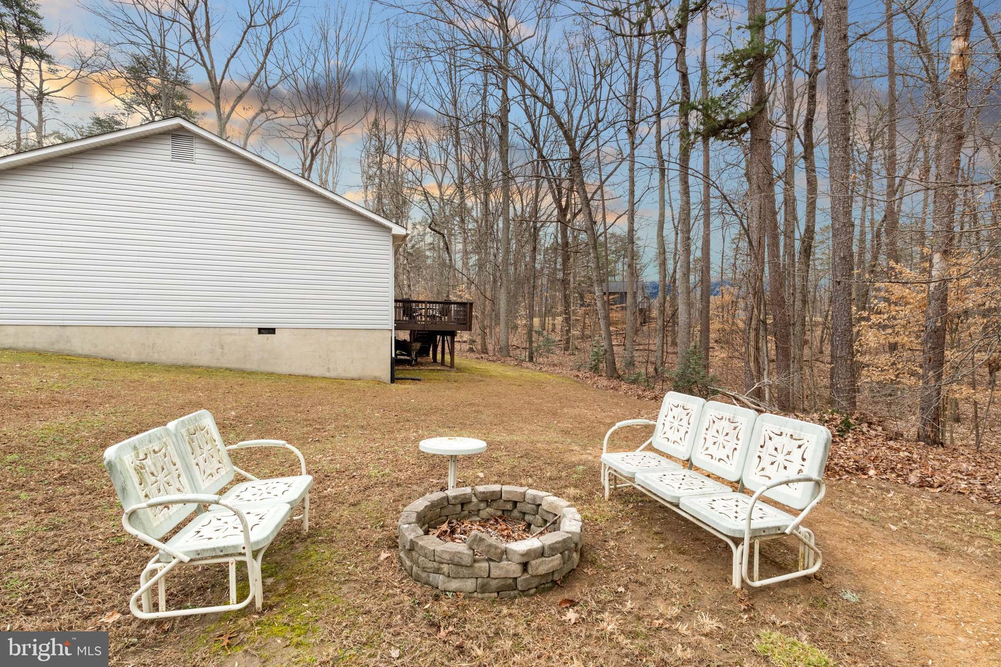 5344 Courtneys Corner Road Sumerduck, VA 22742 - Photo 31 of 56 a backyard of a house with table and chairs