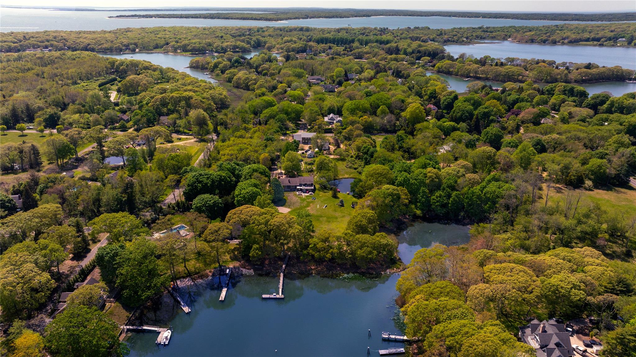 Bird's eye view of a heavily wooded area and a large body of water