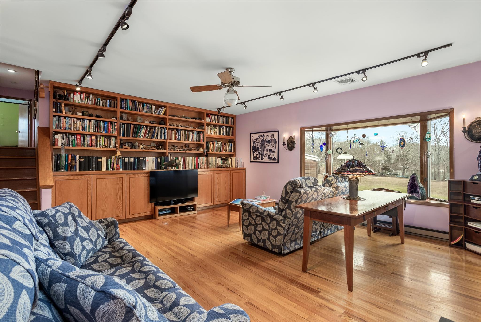 15 South Menantic Road Shelter Island, NY 11964 - Photo 12 of 44 a living room with furniture a flat screen tv and floor to ceiling window