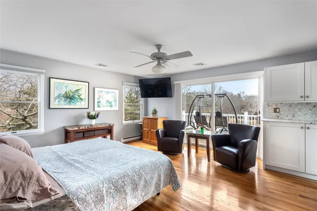 a bathroom with a granite countertop sink a mirror and shower