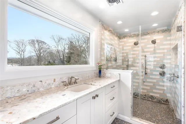 a kitchen with stainless steel appliances a stove a microwave and cabinets