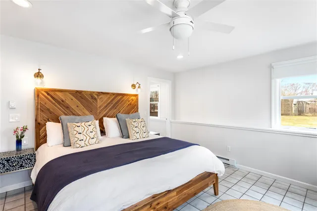 a spacious bedroom with furniture and a large window