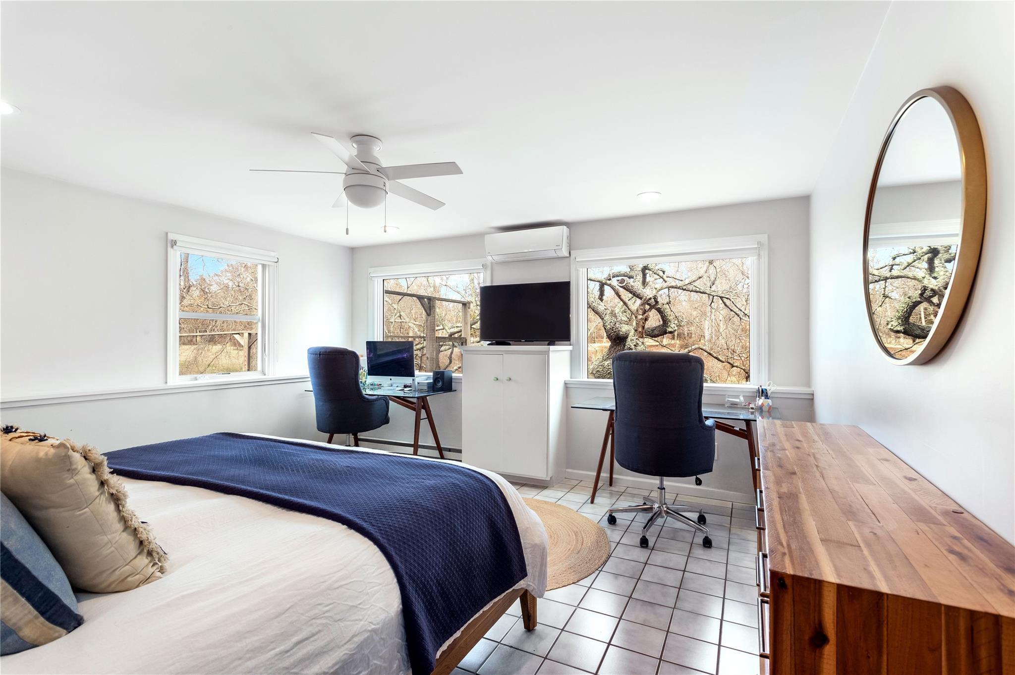 15 South Menantic Road Shelter Island, NY 11964 - Photo 22 of 44 a bed room with a bed tv and a window