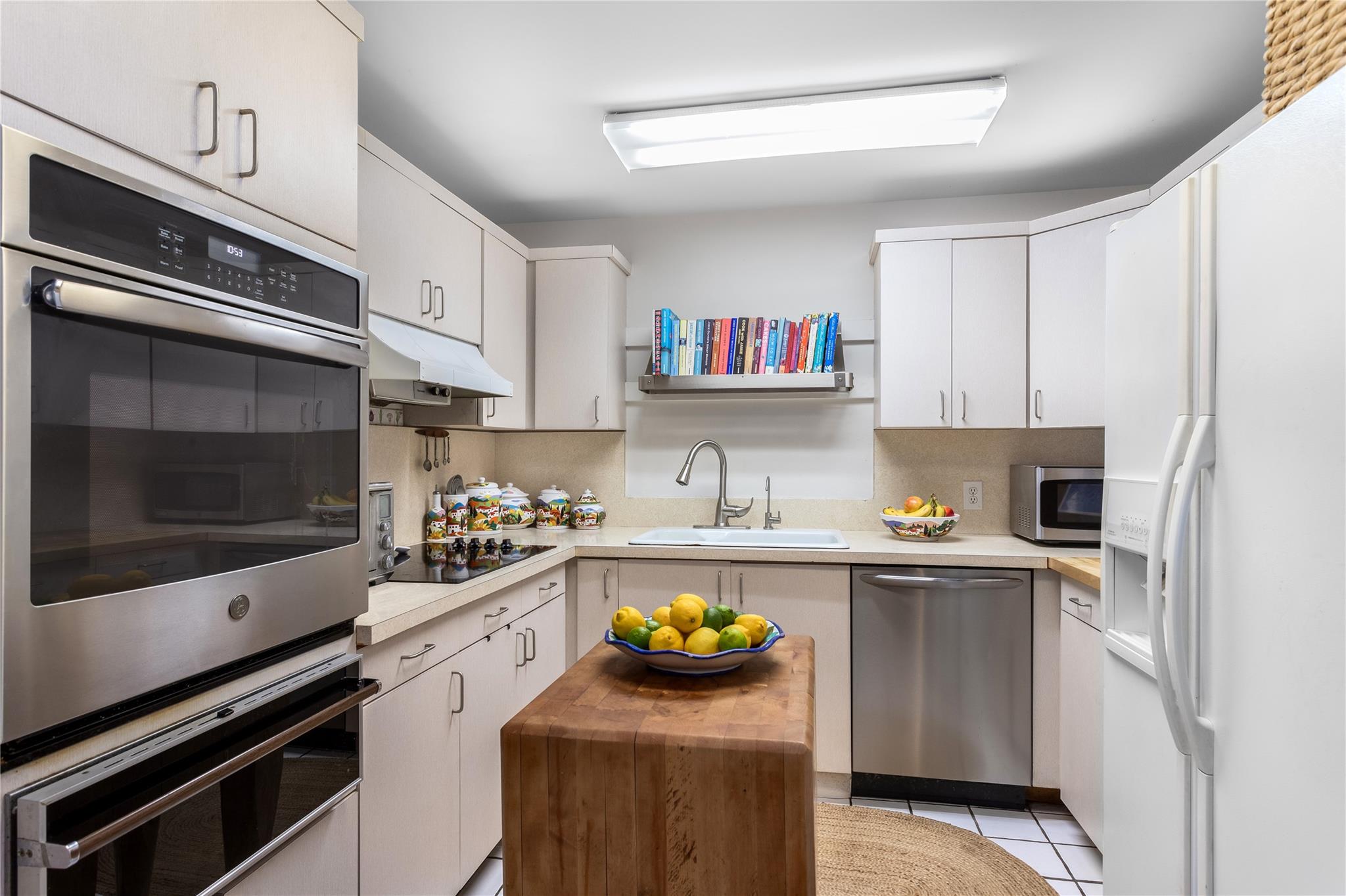 15 South Menantic Road Shelter Island, NY 11964 - Photo 24 of 44 a kitchen with stainless steel appliances a stove a microwave and cabinets