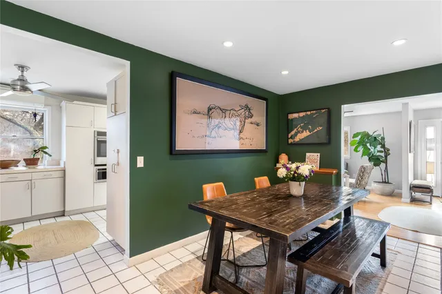 a bedroom with a bed and large windows