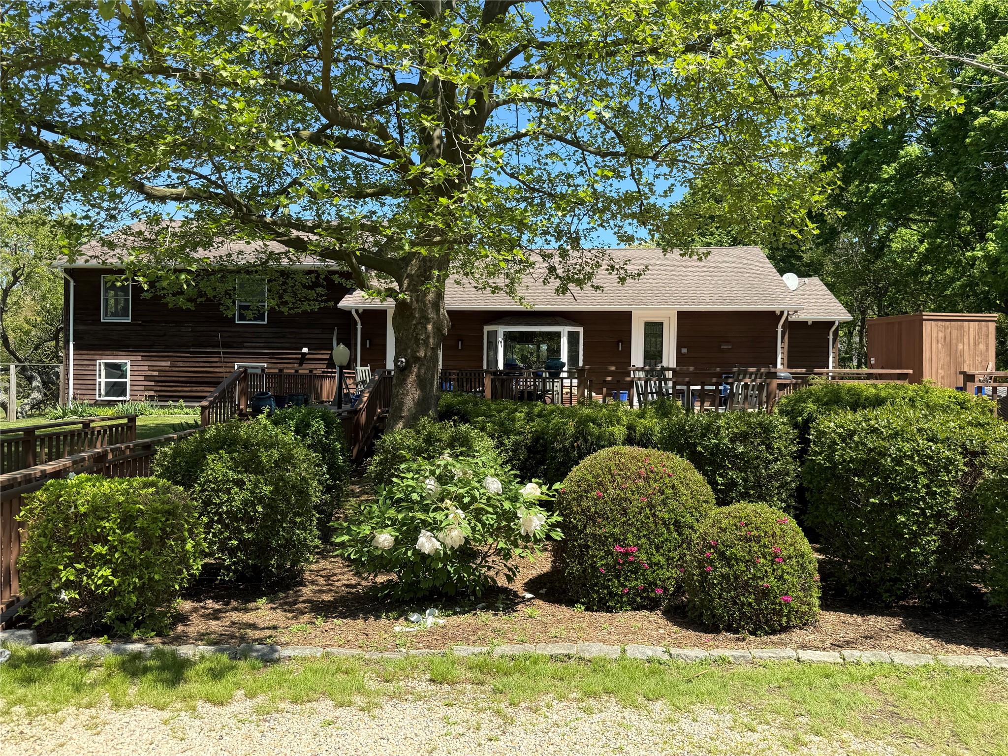 15 South Menantic Road Shelter Island, NY 11964 - Photo 3 of 44 a front view of a house with a yard