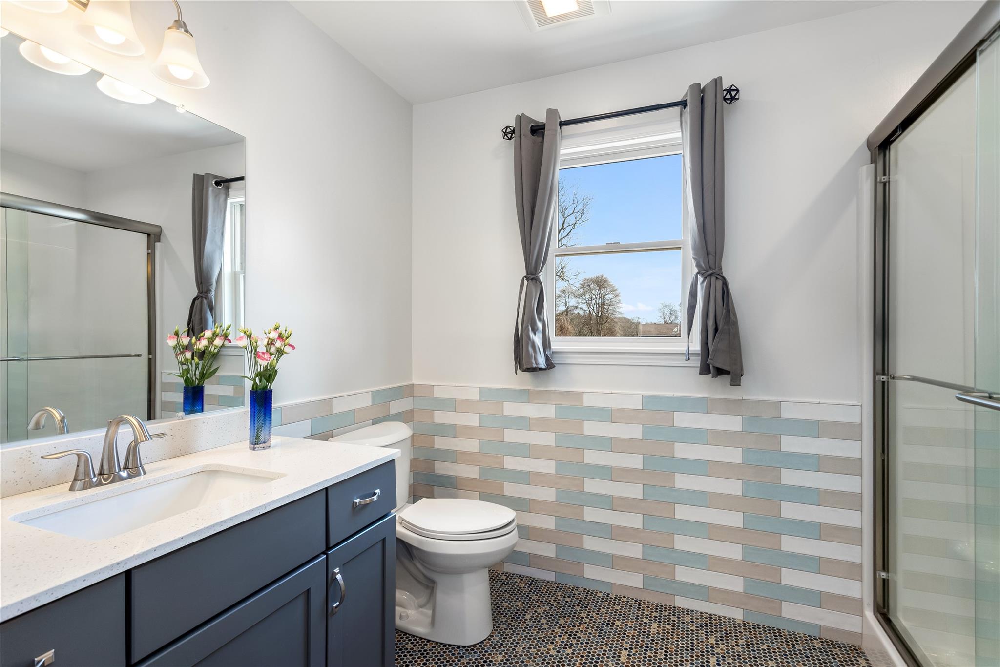15 South Menantic Road Shelter Island, NY 11964 - Photo 38 of 44 a bathroom with a sink a toilet and mirror