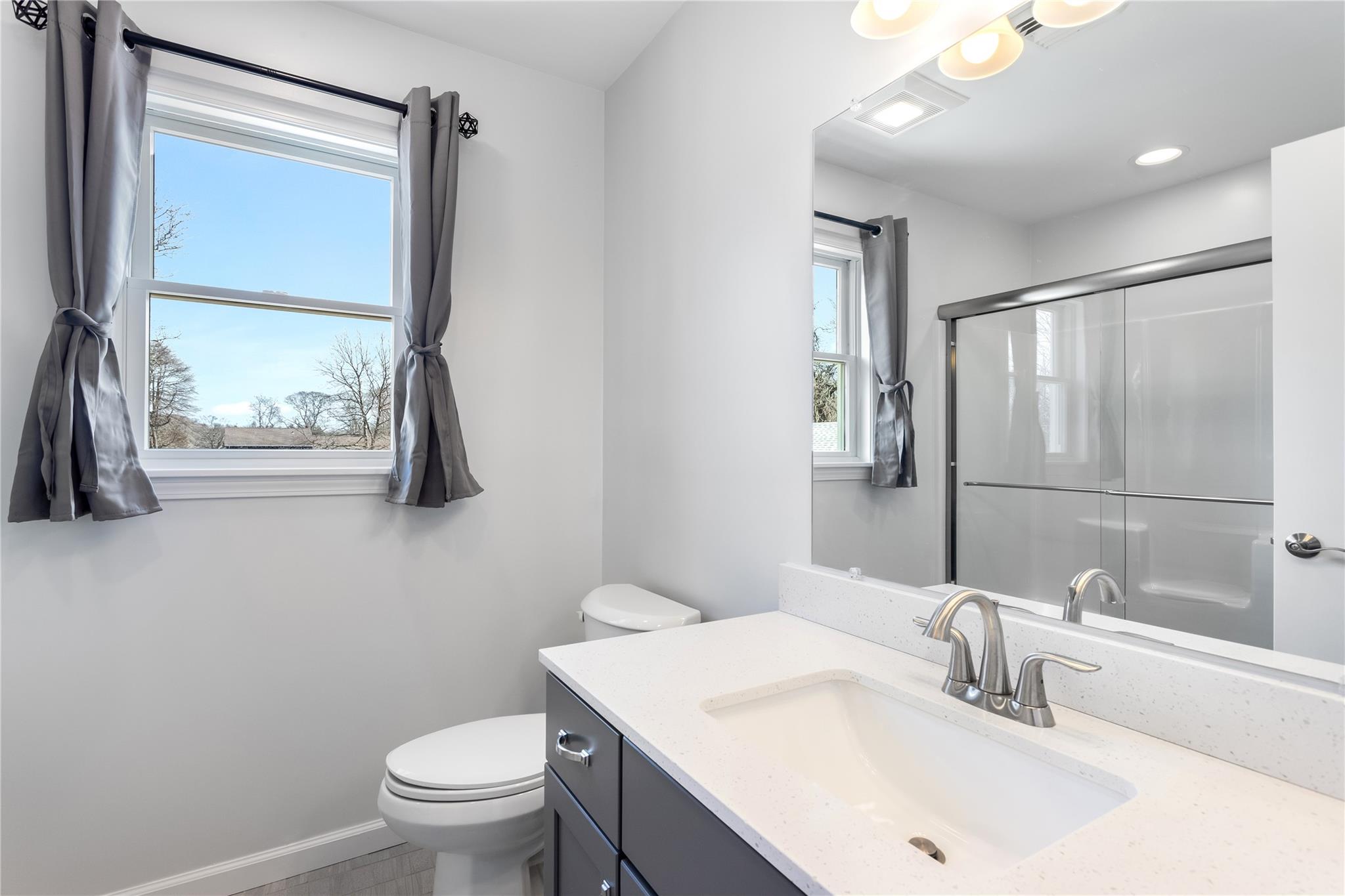 15 South Menantic Road Shelter Island, NY 11964 - Photo 39 of 44 a bathroom with a sink a toilet and a mirror