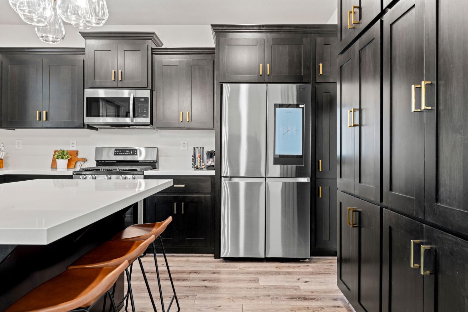 3017 Checkerspot Street Roseville, CA 95747 - Photo 11 of 57 a kitchen with stainless steel appliances a refrigerator and a stove top oven