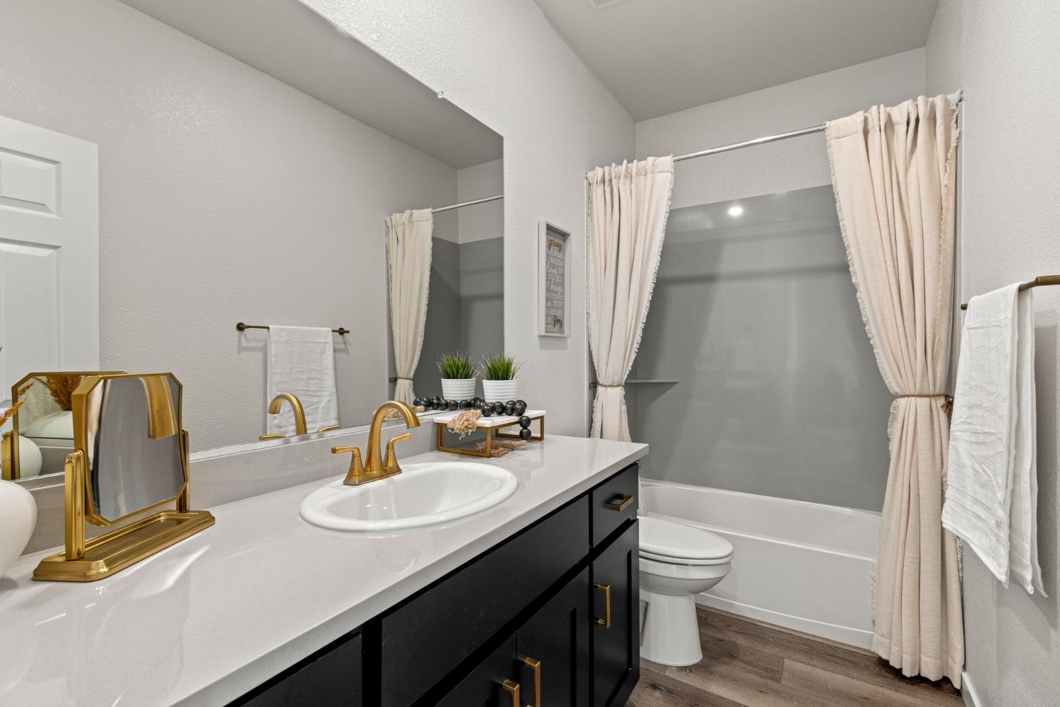 3017 Checkerspot Street Roseville, CA 95747 - Photo 40 of 57 a bathroom with a sink a toilet and shower