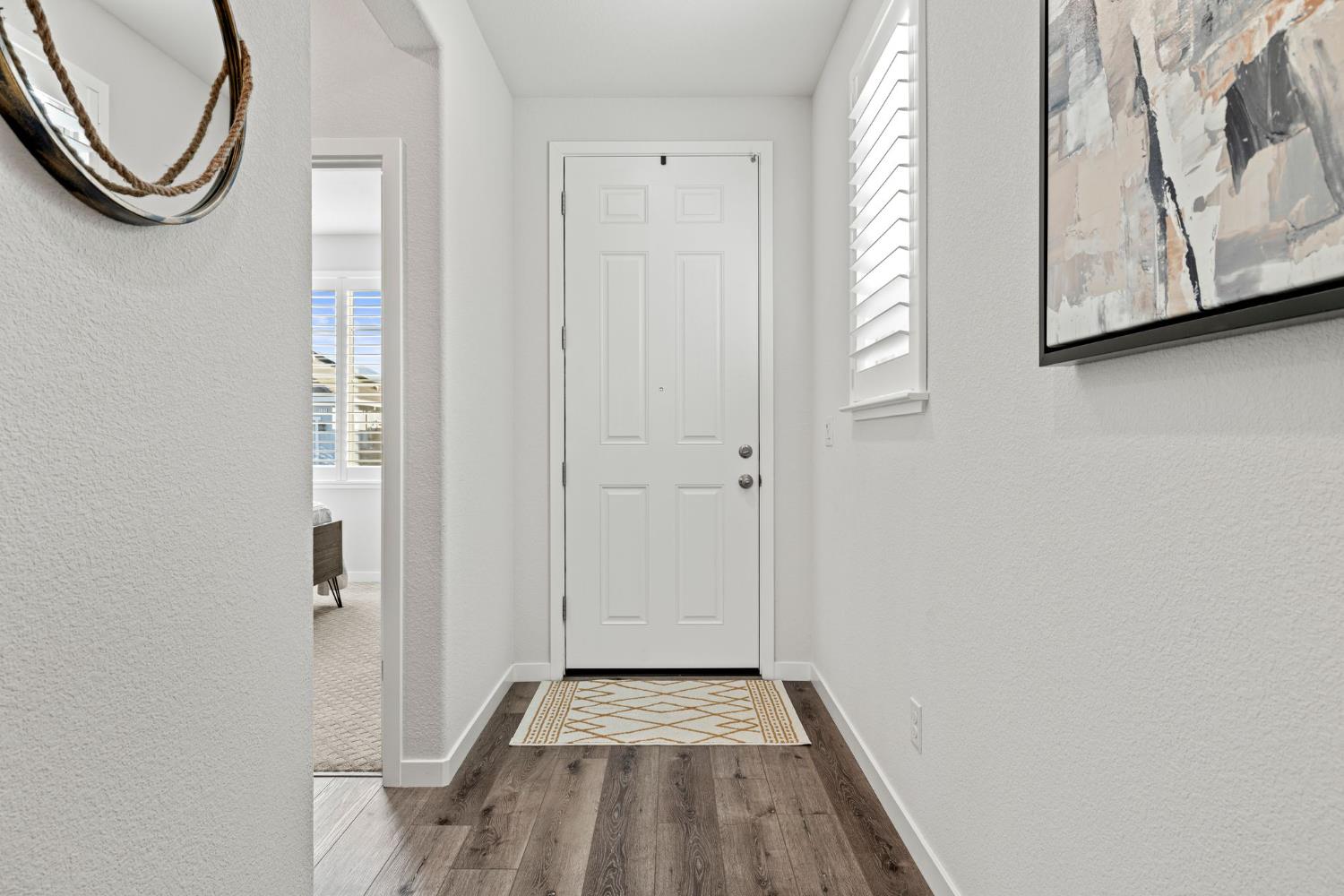 3017 Checkerspot Street Roseville, CA 95747 - Photo 5 of 57 a view of a room with wooden floor and white walls