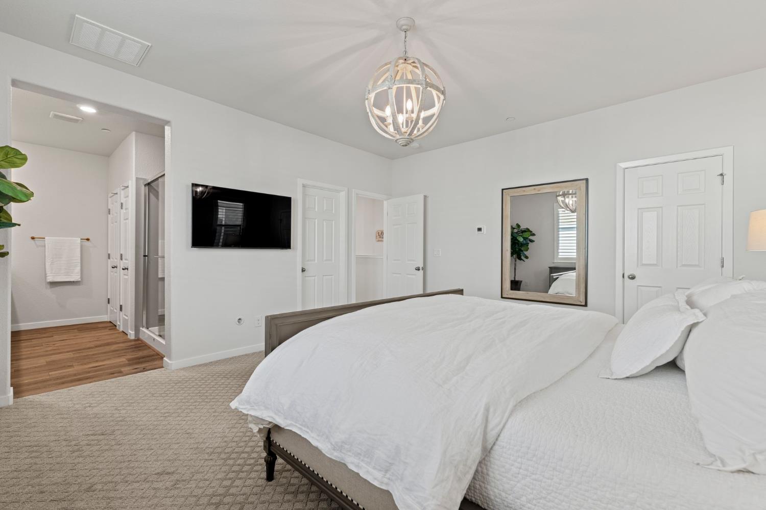 3017 Checkerspot Street Roseville, CA 95747 - Photo 51 of 57 a spacious bedroom with a bed and a flat tv screen on dresser