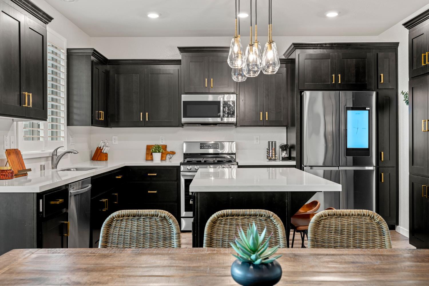 3017 Checkerspot Street Roseville, CA 95747 - Photo 10 of 57 a kitchen with stainless steel appliances kitchen island granite countertop a refrigerator a sink a stove and wooden cabinets