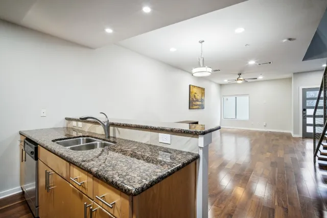 a kitchen with kitchen island a sink and a stove