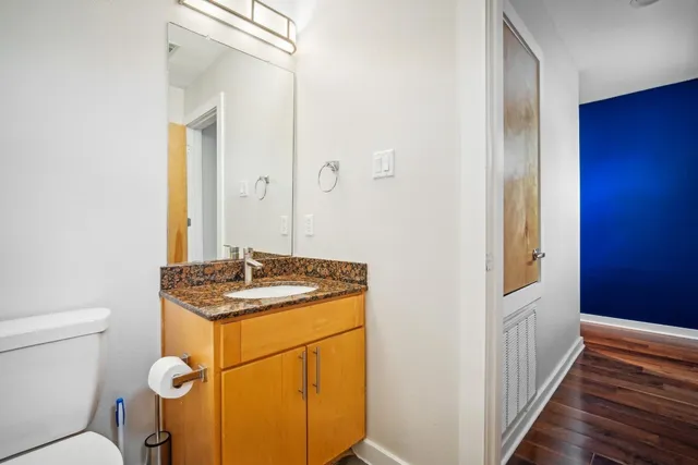a bathroom with a sink toilet and mirror