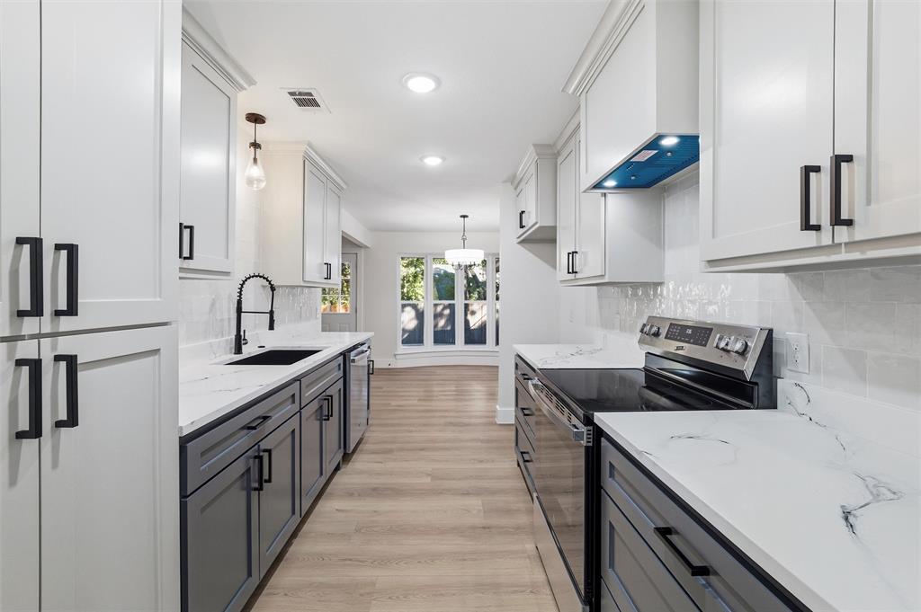 3909 Rustic Forest Trail Arlington, TX 76016 - Photo 4 of 14 a kitchen with stainless steel appliances a sink stove and cabinets