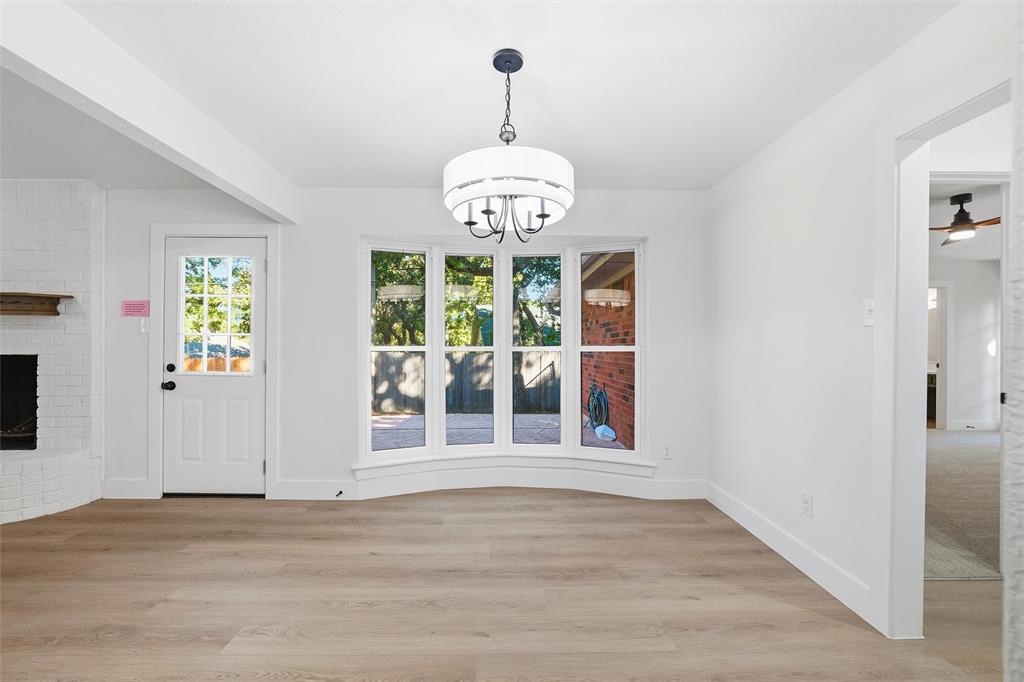 3909 Rustic Forest Trail Arlington, TX 76016 - Photo 5 of 14 a view of an empty room with wooden floor and a window