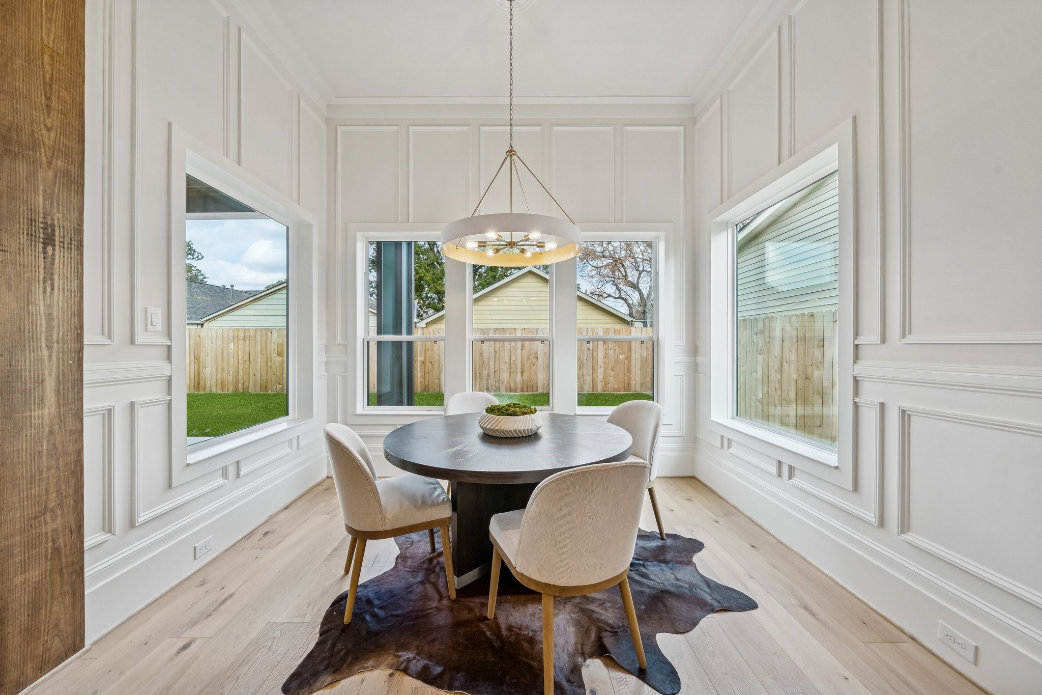 511 Graceland Street Houston, TX 77009 - Photo 12 of 45 A dining room surrounded by windows to the back yard. This room is outfitted with box moldings as well.