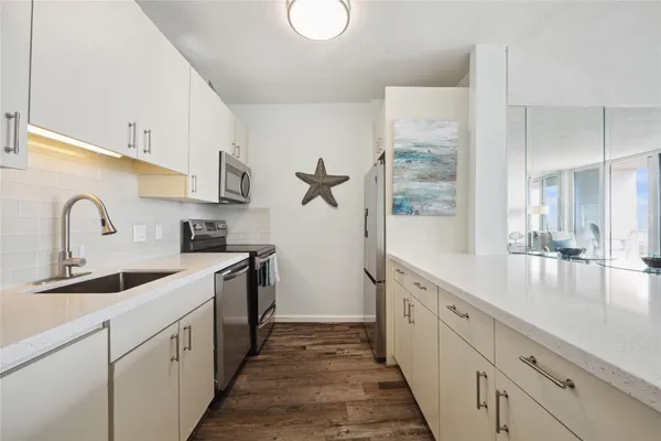 a kitchen with sink a window and appliances