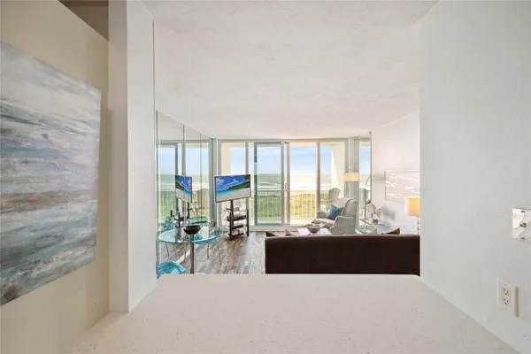 a living room with furniture large windows and a floor to ceiling window
