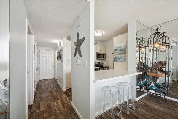 a very nice looking room with a large window and wooden floor