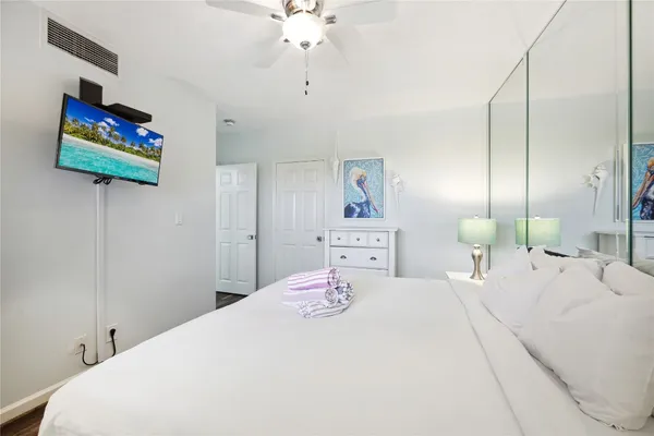 a bedroom with a bed and a chandelier