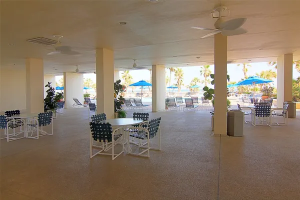 a view of a swimming pool with outdoor seating