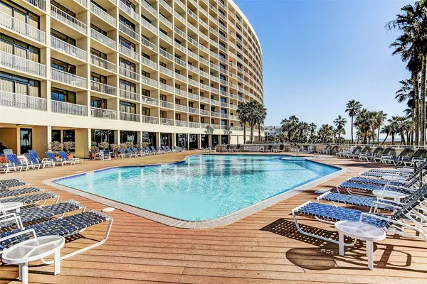 a view of a swimming pool with a lounge chairs