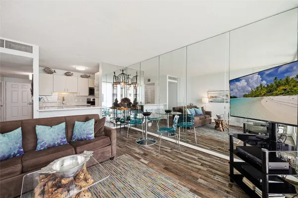 a living room with lots of furniture and a wooden floor