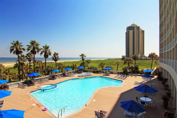 a view of swimming pool with outdoor seating space