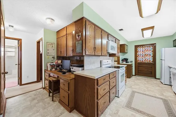 a kitchen with a sink stove and cabinets
